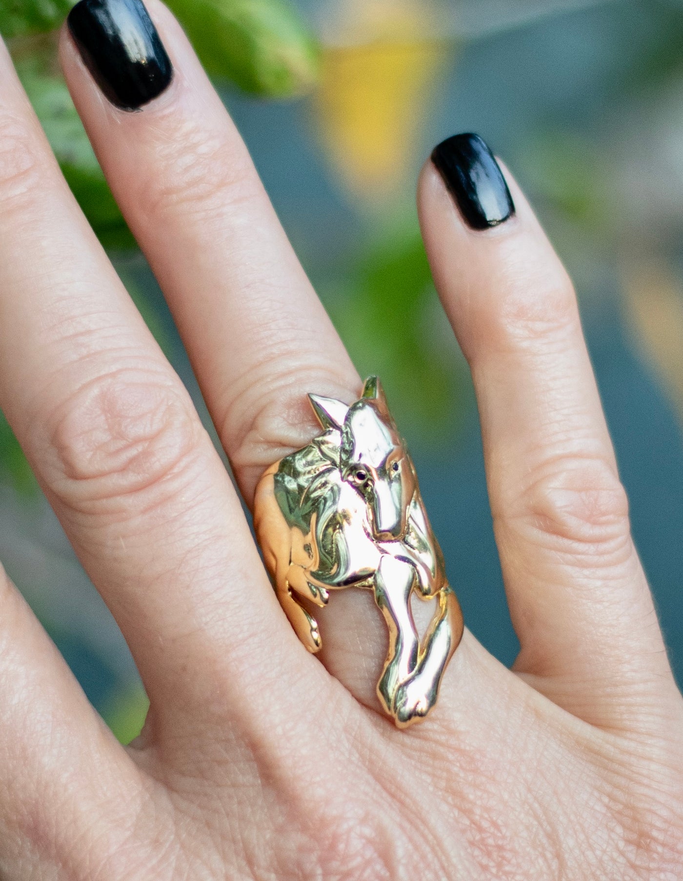 Gold wolf wrap ring on finger