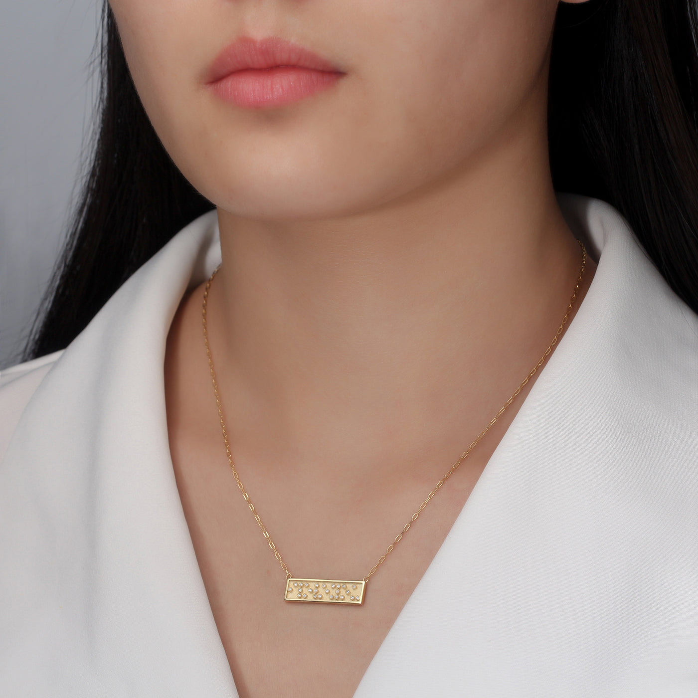 i love you message braille necklace on model by Touchstone