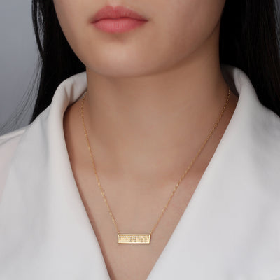 fearless Braille bar necklace on model by Touchstone