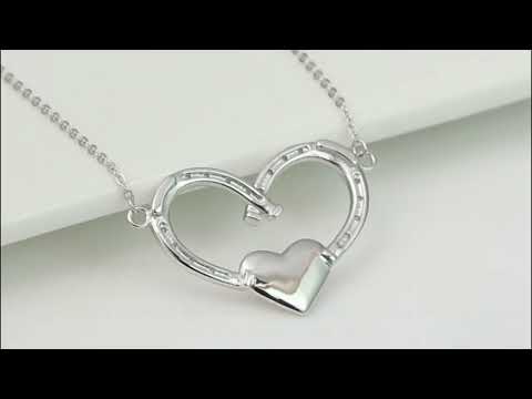 Add a touch of equestrian charm to your jewelry collection with this beautiful Dark Horse Luck in My Heart Horseshoes Necklace in Silver. Crafted from high-quality silver, this necklace features a delicate chain and two horseshoe pendants, one smaller and one larger, placed in a heart shape. The horseshoes are believed to bring good luck, making this necklace a meaningful and stylish accessory. Perfect for horse lovers or anyone looking to add some luck to their daily wear, this necklace is a must-have.